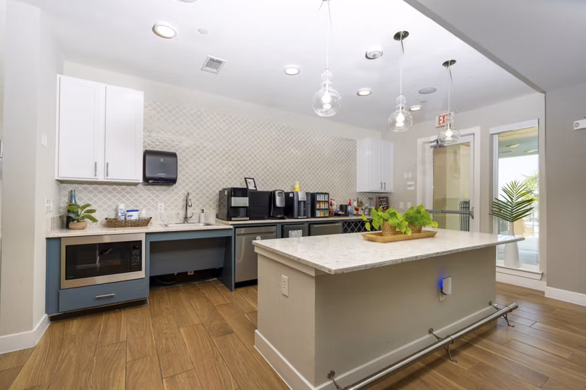Modern clubhouse kitchen with stainless steel appliances at Sage Stone Oak Apartments