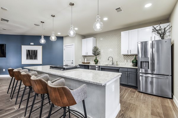 Modern clubhouse kitchen with stainless steel appliances at Sage Stone Oak Apartments