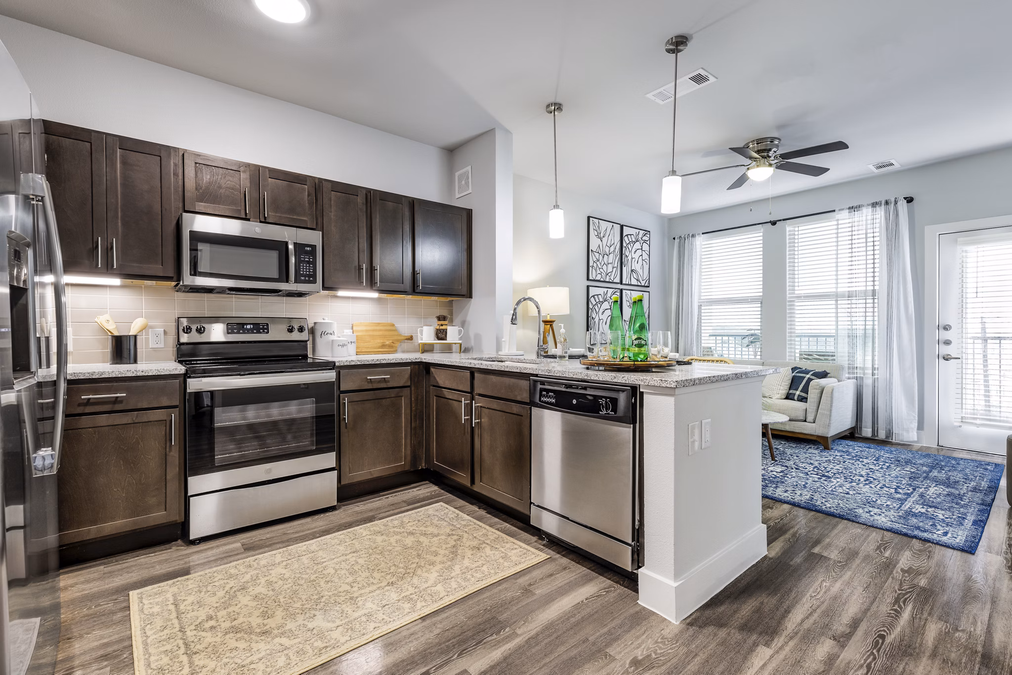 Modern kitchen with stainless steel appliances and quartz countertops at Sage Stone Oak Apartments in San Antonio