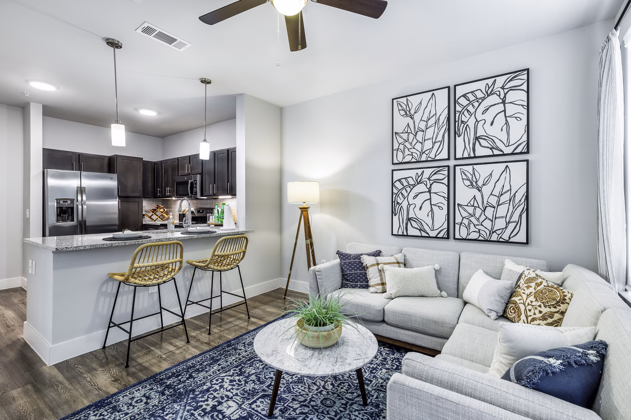 Spacious living room with modern decor in Sage Stone Oak Apartments, featuring comfortable seating and large windows