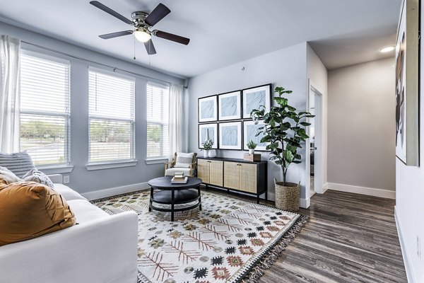 Spacious, modern living room with elegant furnishings at Sage Stone Oak Apartments, showcasing luxury urban living