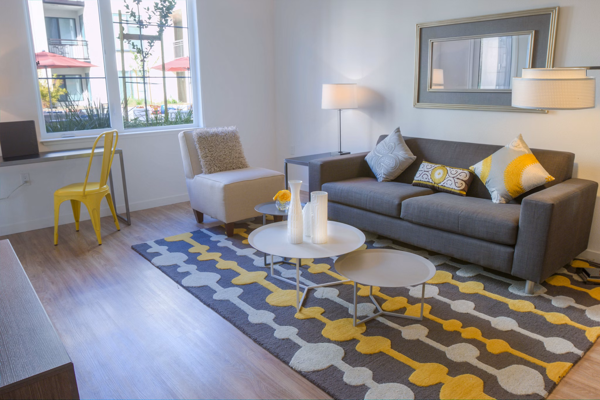 Modern living room with sleek furnishings and large windows at mResidences Mountain View Apartments, offering luxury living in a serene location