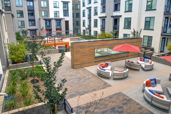 Charming patio at mResidences Mountain View Apartments with cozy seating and lush greenery, offering a serene outdoor space for residents to relax