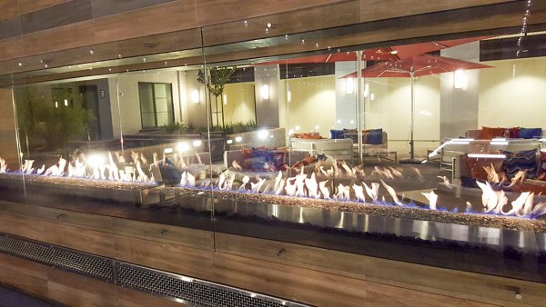 Fire pit on modern patio at mResidences Mountain View Apartments, offering a cozy outdoor gathering space with scenic views