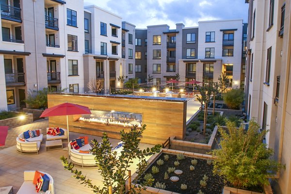 Fire pit and grill patio area at mResidences Mountain View Apartments, perfect for outdoor gatherings and relaxation