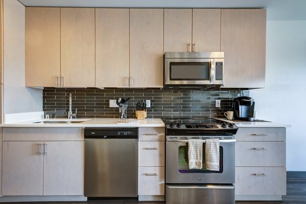 Modern kitchen with sleek appliances at mResidences South Lake Union Apartments