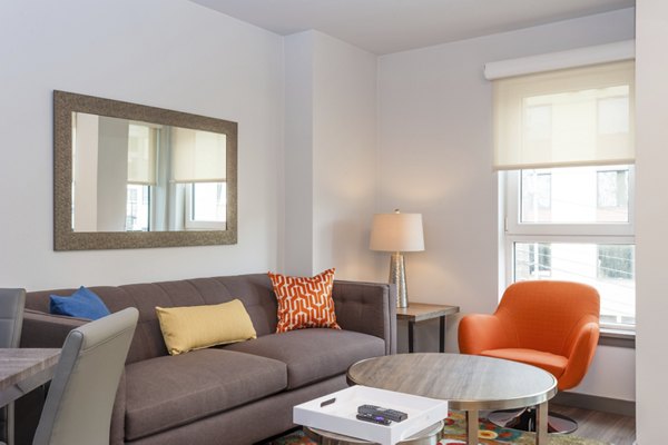 Spacious living room with modern decor in mResidences South Lake Union Apartments, Seattle, offering luxury amenities and comfort for residents