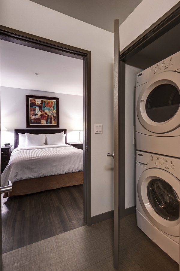 Modern laundry room with high-efficiency washers and dryers at mResidences South Lake Union Apartments