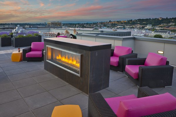 Fire pit seating area at mResidences South Lake Union Apartments: Cozy outdoor space with seating and evening ambiance