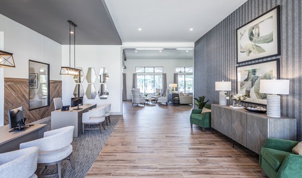 Stylish office lobby featuring modern desks, decorative lighting, and artwork in luxury apartments