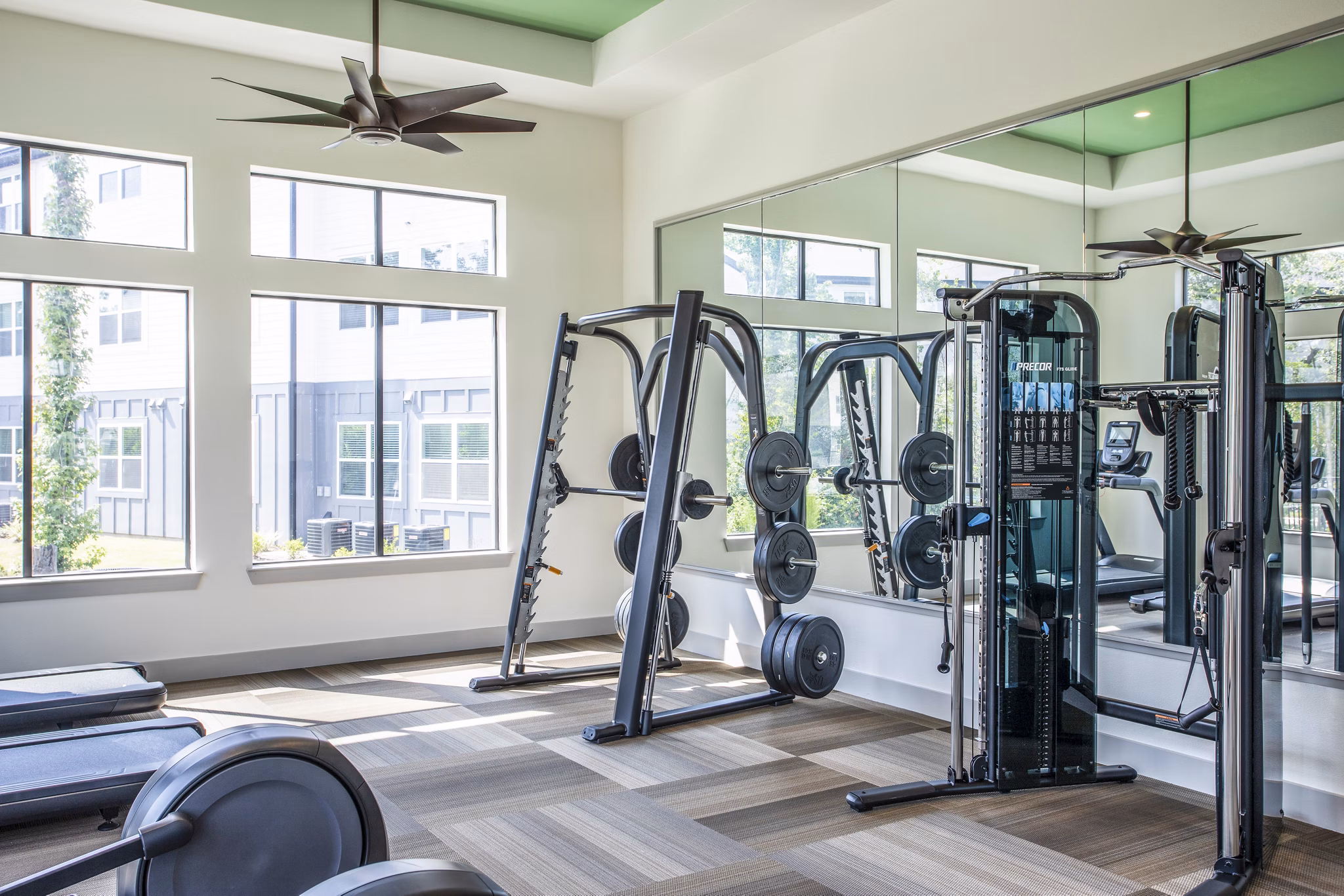 Well-equipped gym with treadmills and weight machines in luxury apartments