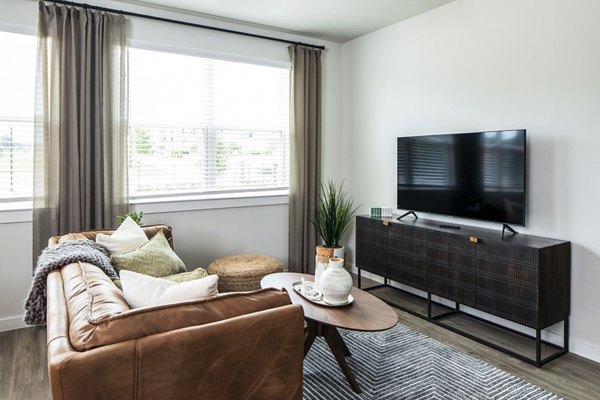 Modern living room featuring brown leather sofa and decorative plants in luxury apartment