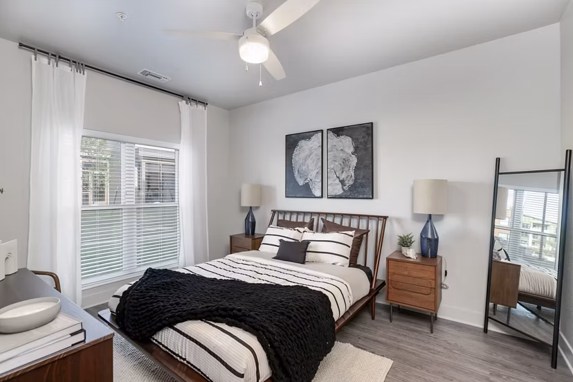 Spacious bedroom with modern furniture and ambient lighting at The Avante Apartments