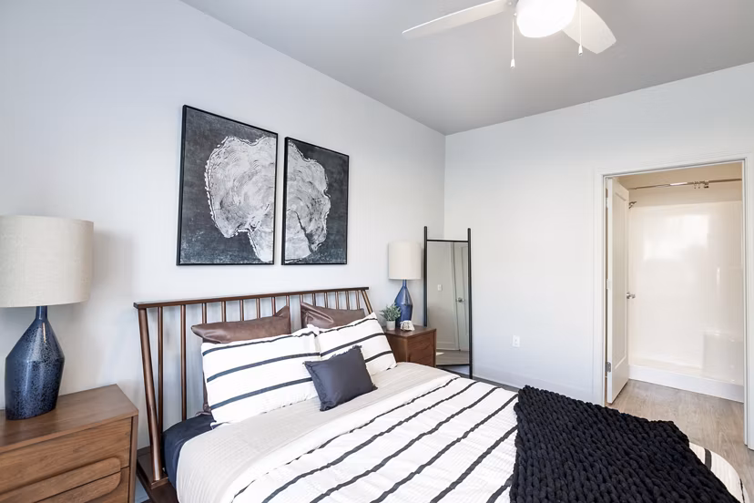 Bedroom featuring modern decor and large windows at The Avante Apartments