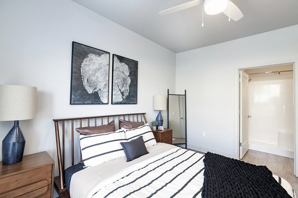 Bedroom featuring modern decor and large windows at The Avante Apartments