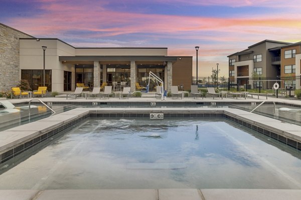 Modern outdoor pool with lounge chairs at The Avante Apartments, perfect for relaxation and leisure activities