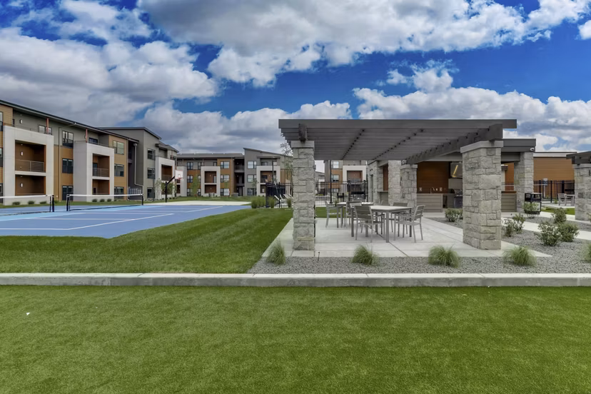 Outdoor courtyard featuring modern seating and lush landscaping at The Avante Apartments