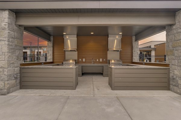 Outdoor grill area with modern seating and sleek design at The Avante Apartments, a luxury community by Greystar