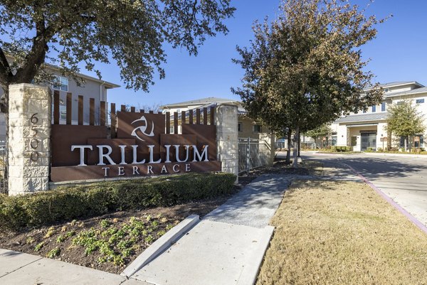 Trillium Terrace: Elegant building facade at luxury apartments in a serene neighborhood, ideal for modern living