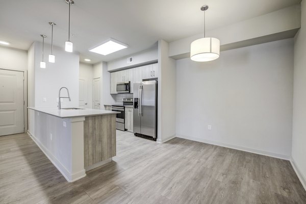 Dining room with contemporary decor at Trillium Terrace Apartments featuring stylish lighting and modern dining set