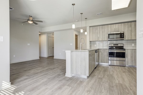 Spacious kitchen with stainless steel appliances in Trillium Terrace Apartments, luxury living by Greystar