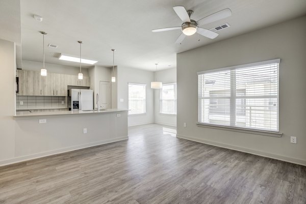 Spacious living room with stylish decor and large windows at Trillium Terrace Apartments