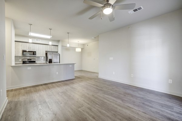 Modern living room with elegant decor at Trillium Terrace Apartments, luxury Greystar property with spacious seating and natural lighting