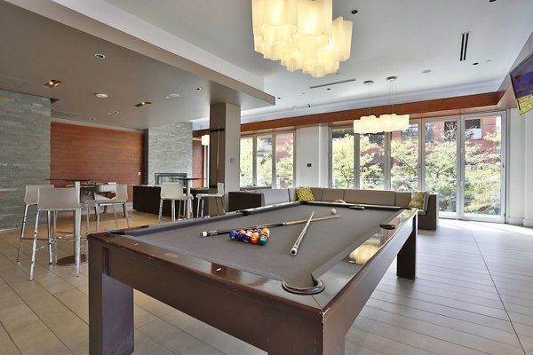 Game room featuring billiards and lounge area at 1600 Glenarm Place Apartments