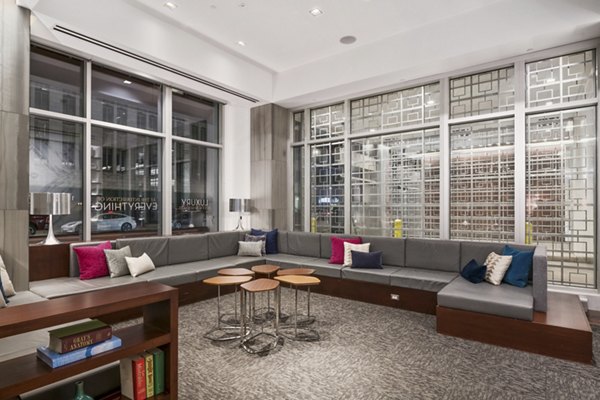 1600 Glenarm Place Apartments: Modern clubhouse with sleek design and comfortable seating
