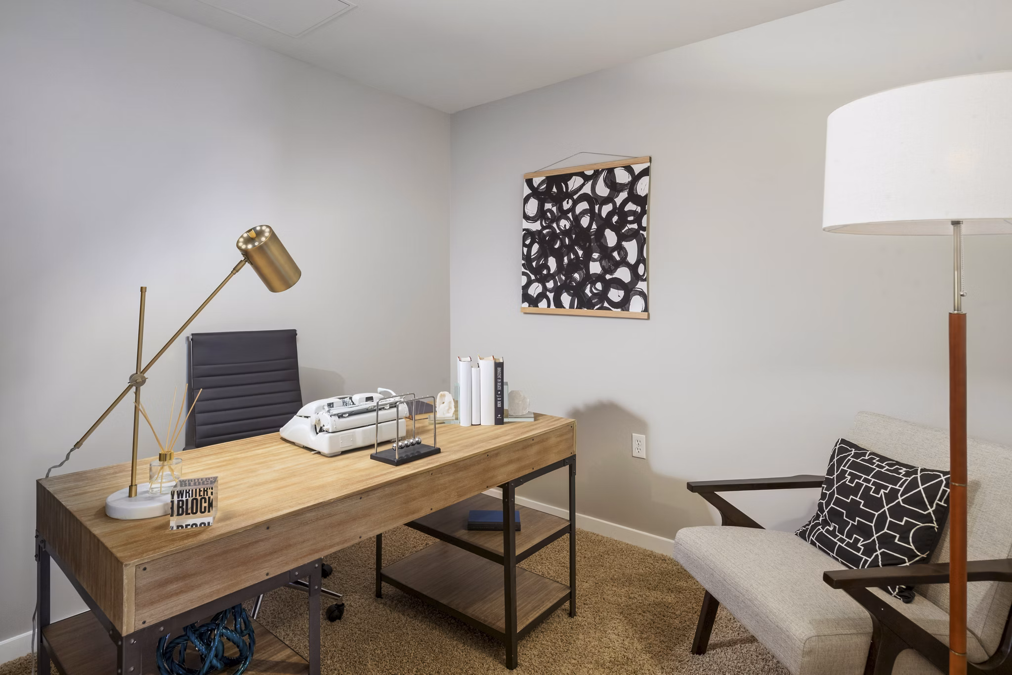 Home office with modern decor and ample lighting at 1600 Glenarm Place Apartments
