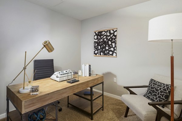 Home office with modern decor and ample lighting at 1600 Glenarm Place Apartments