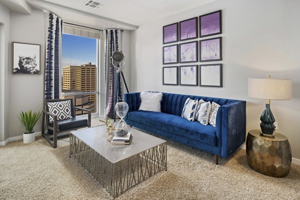 Elegant living room featuring modern decor and large windows at 1600 Glenarm Place Apartments