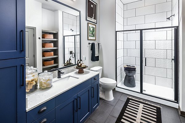 Luxurious bathroom featuring marble countertops and modern fixtures at Beckon Apartments