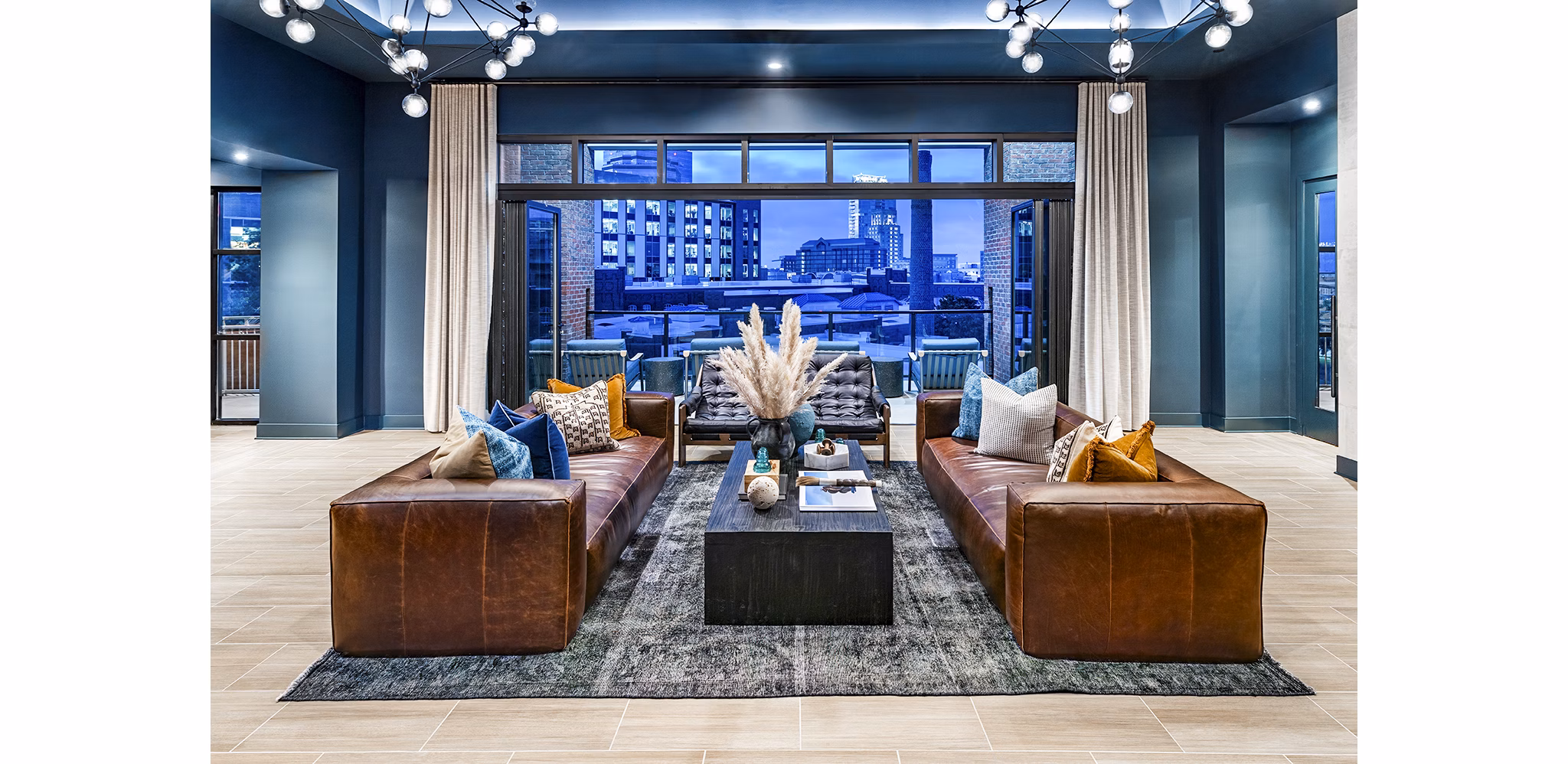 Modern clubhouse featuring cozy seating and entertainment areas at Destinations Pueblo Apartment Homes