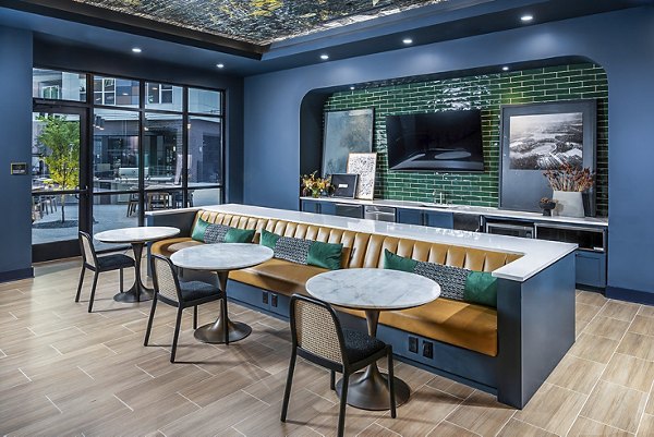 Clubhouse featuring modern lounge seating and game area at Beckon Apartments