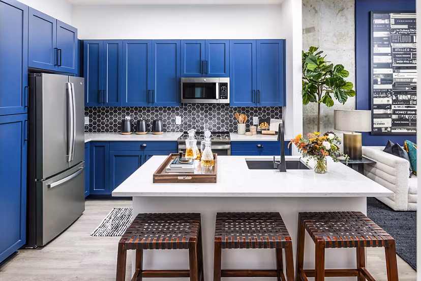Modern kitchen with sleek cabinetry and stainless steel appliances in Beckon Apartments