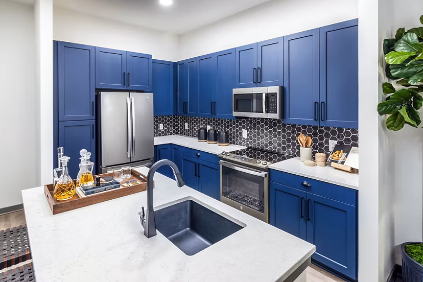 Modern kitchen with stainless steel appliances in Beckon Apartments
