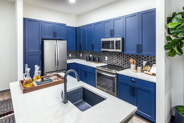 Modern kitchen with stainless steel appliances in Beckon Apartments