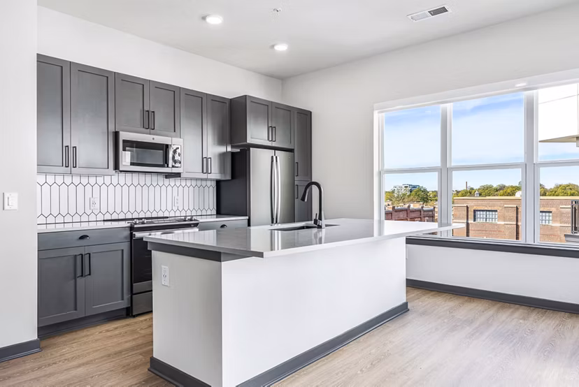 Modern kitchen with stainless steel appliances at Beckon Apartments, luxury living space in Greystar community
