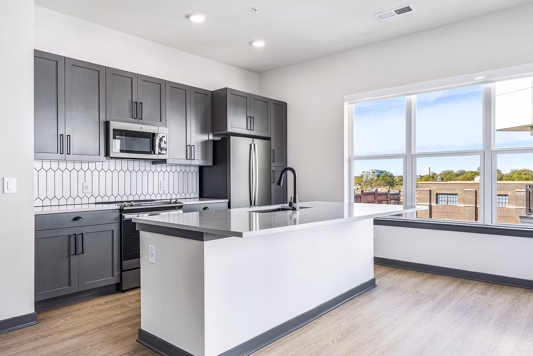Modern kitchen with stainless steel appliances at Beckon Apartments, luxury living space in Greystar community
