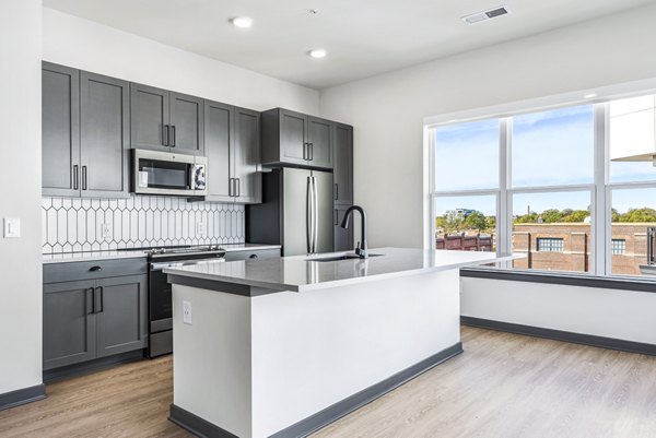 Modern kitchen with stainless steel appliances at Beckon Apartments, luxury living space in Greystar community