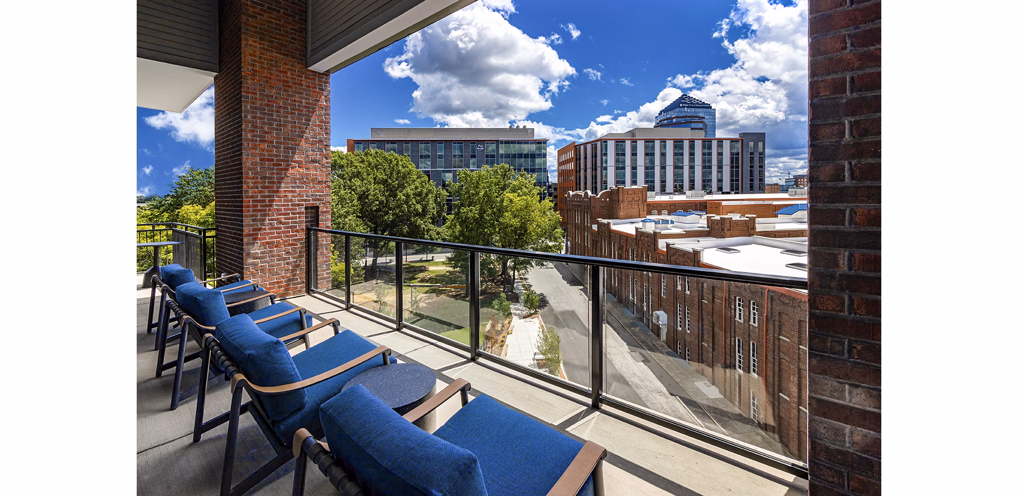 Expansive outdoor patio with seating and city views at Beckon Apartments, luxury living by Greystar