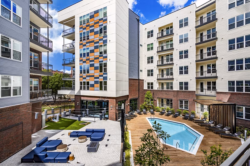 Resort-style swimming pool with lounge chairs at Beckon Apartments, offering luxury living experiences for residents