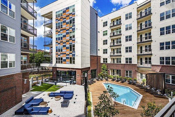 Resort-style swimming pool with lounge chairs at Beckon Apartments, offering luxury living experiences for residents