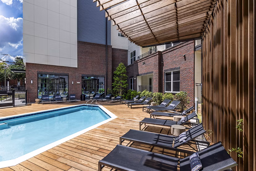 Rooftop pool with sun loungers at Beckon Apartments offering luxury living in a serene setting