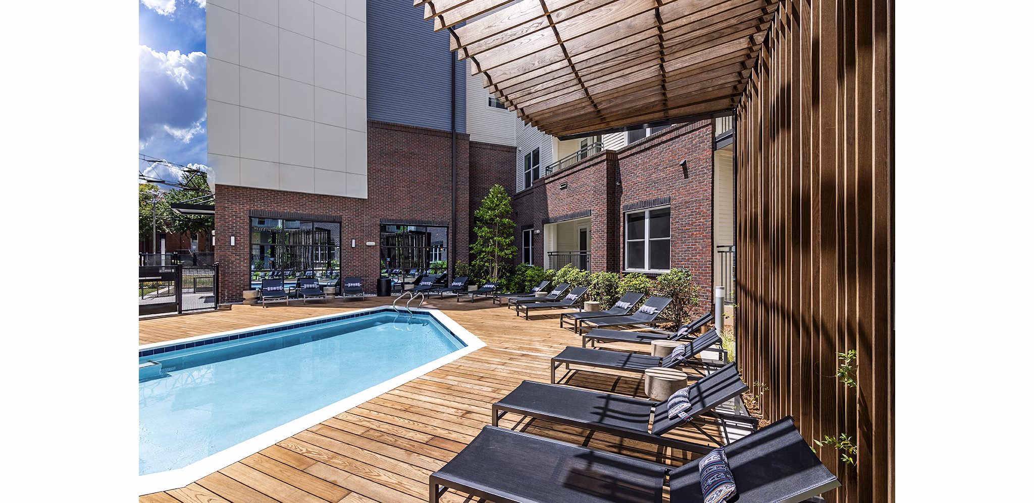 Rooftop pool with sun loungers at Beckon Apartments offering luxury living in a serene setting
