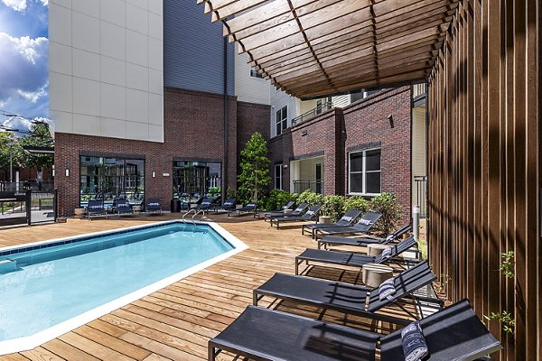 Rooftop pool with sun loungers at Beckon Apartments offering luxury living in a serene setting
