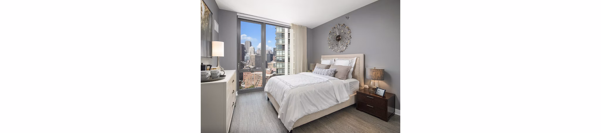 Luxurious bedroom with modern furnishings at 1001 S State Apartments, offering comfort and style in a premium living environment