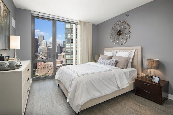 Luxurious bedroom with modern furnishings at 1001 S State Apartments, offering comfort and style in a premium living environment