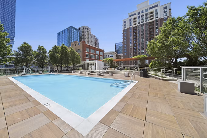 Rooftop pool with city skyline views at 1001 S State Apartments, offering luxury amenities in the heart of the city